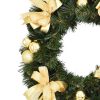 Artificial decorated green Advent wreath in gold color