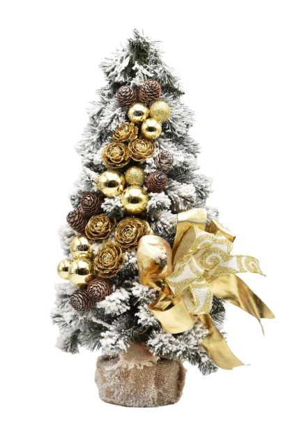 Small decorated flocked Christmas tree in gold color